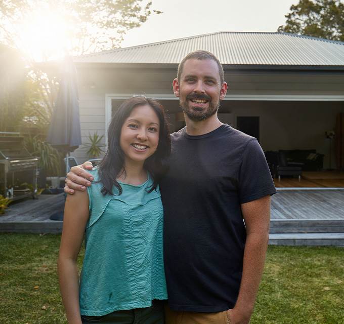 A couple standing outside a new home